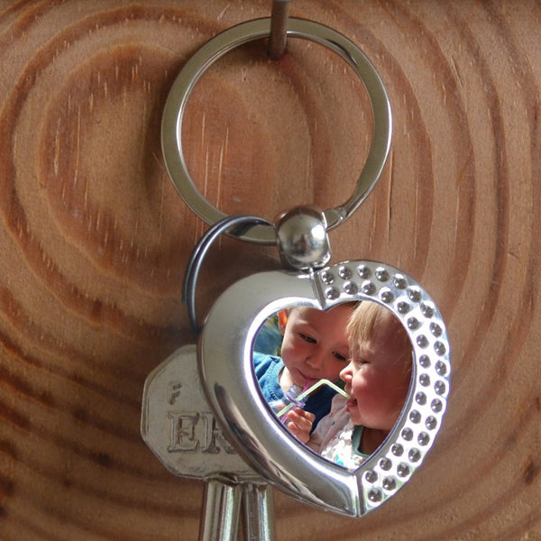 A Personalised metal heart keyring with a family photo in the centre 