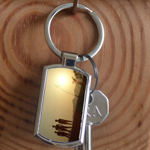 A personalised metal keyring in a rectangular shape featuring a personal photo 